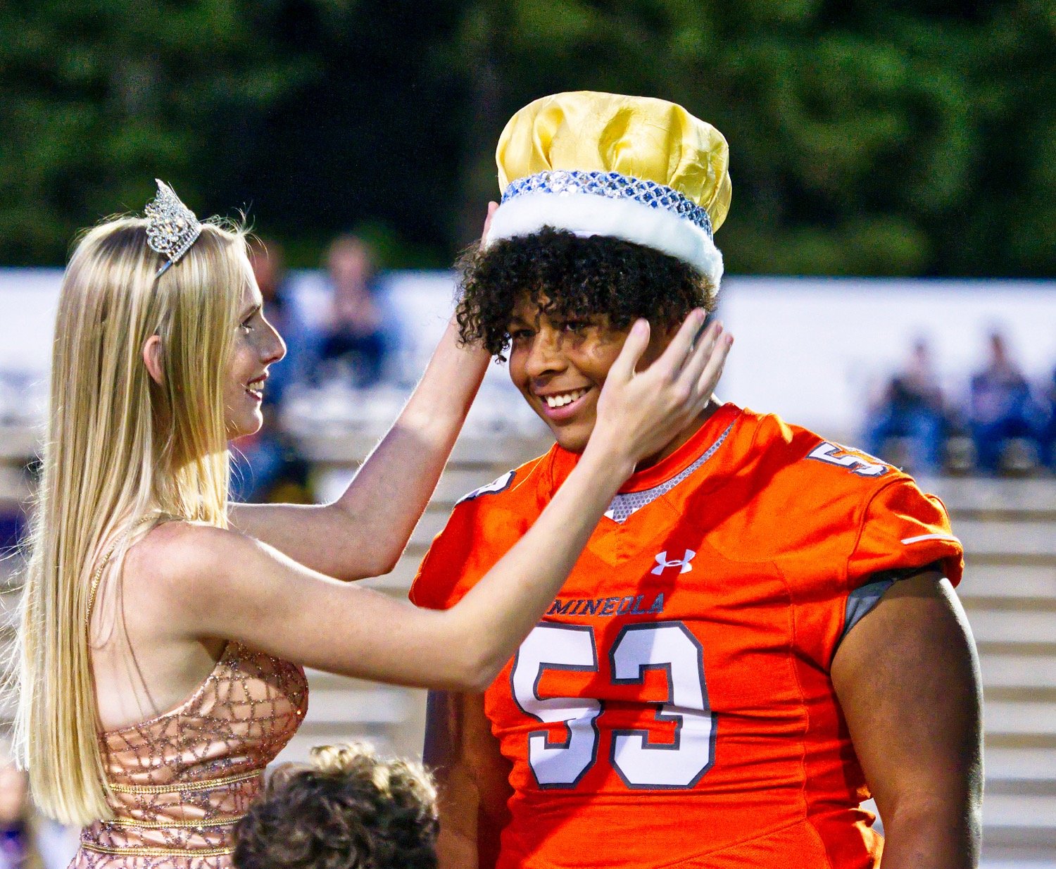 Isaiah Gardner is crowned 2022 Mineola homecoming king by 2021 queen Becca Hughes.